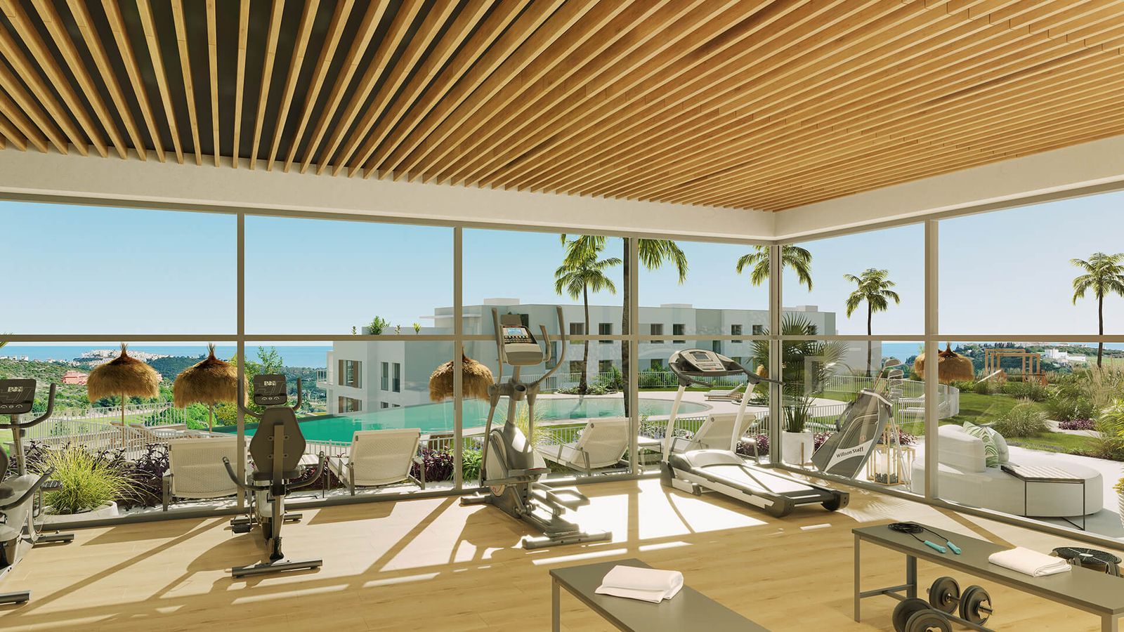 Modernes Fitnessstudio mit atemberaubendem Meerblick und Fitnessgeräten.